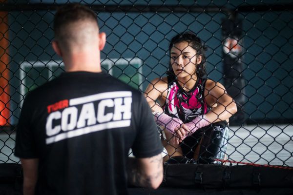 Tiger Muay Thai Head Coach George Hickman speaks with rIka Ishige after a training session